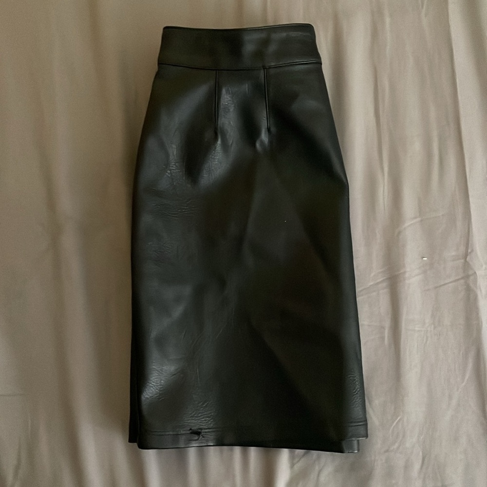 I’m not sure if some would call it a leather skirt.  It’s black super cute! :)